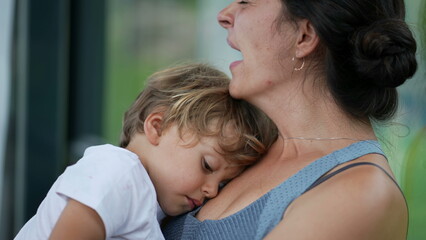 Tired mother yawning holding exhausted child in arms sleepy parent and kid