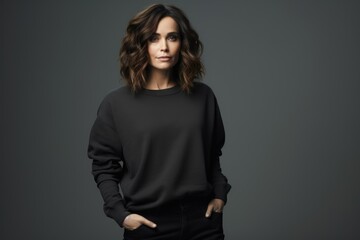 Portrait of a beautiful fictional woman smiling. Brunette model wearing an oversized black sweatshirt. Isolated on a plain colored background. Generative AI illustration.