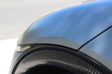 Closeup of modern styling on unbranded car background image.