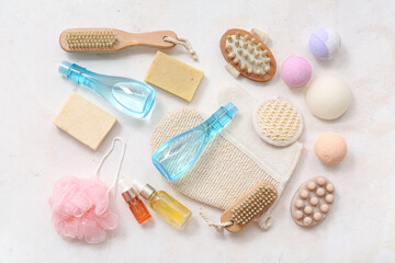 Composition with different bath accessories and cosmetic products on light background