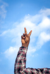 An inspiring image of two fingers raised to the sky signifying victory and determination.