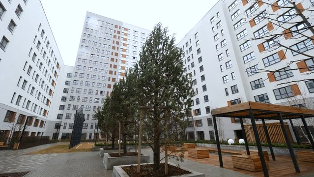 A closed courtyard with tall houses. Stock footage. Large high-rise houses around enclosed courtyards with playgrounds.