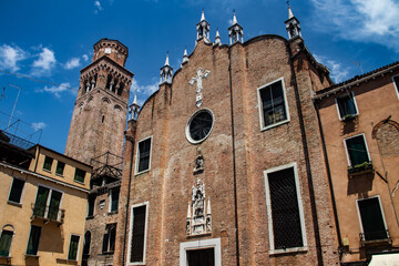 Historic brick church facade and round window in Italy © Miros