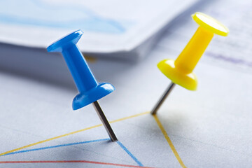 Marking financial chart by pins.Share listing and checking financial chart. Concept of banking, financial report and financial audit.