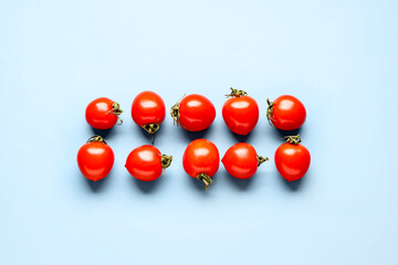 Many fresh cherry tomatoes on blue background