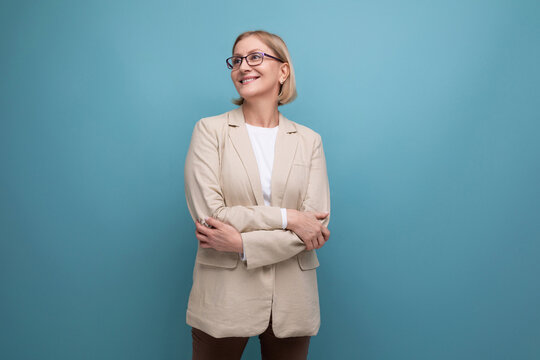 Portrait Of A Successful Business 40s Mature Lady In A Classic Jacket On A Bright Background With Copy Space