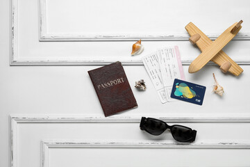Composition with sunglasses, credit card, tickets and passport on light background