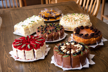 7 diffrerent cake on wooden table