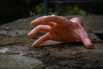 Scary realistic human hand with scars and stiches. Cut off hand with active fingers. Plastic toy.
