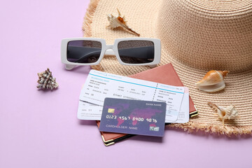 Composition with credit card, tickets, female accessories and seashells on lilac background