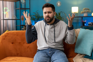 What. Why. Caucasian man raising hands in indignant expression asking reason of failure...