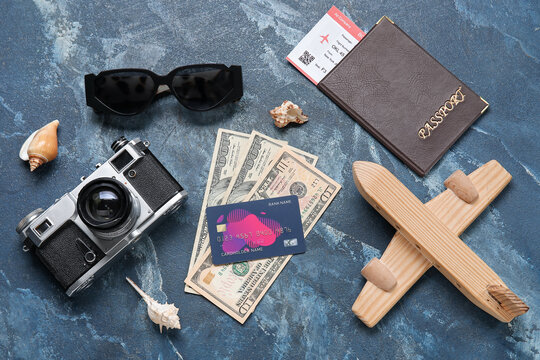 Composition with credit card, money, photo camera and sunglasses on color background