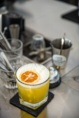 a glass of lemonade with dryed lemon sliced on beverage table