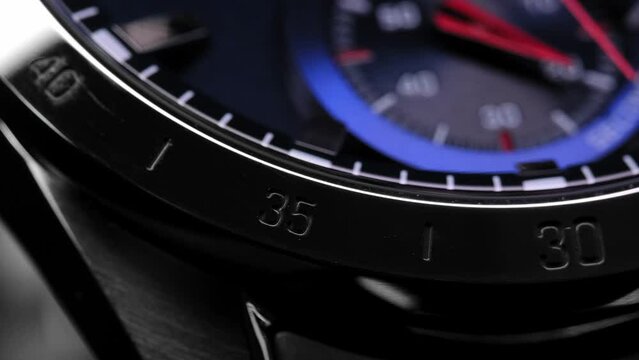 Close Up Of Stylish Luxury Man Wrist Watch With Moving Hand And Multiple Dials. Men's Swiss chronograph watch in metal with sapphire crystal. closeup view of rotating watch , running second arrow
