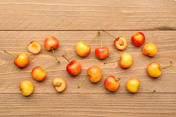 Many sweet yellow cherries on wooden background