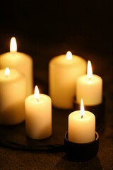 Fototapeta na wymiar Beautiful burning candles on black background
