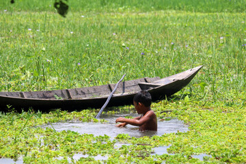 Kids riding boat in rice farm Bangladeshi childhood hi-res stock photography and images 