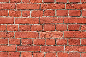 Texture of an old damaged red brick wall as an architectural background