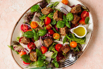 Herring and vegetables summer salad .top veiw.selective focus