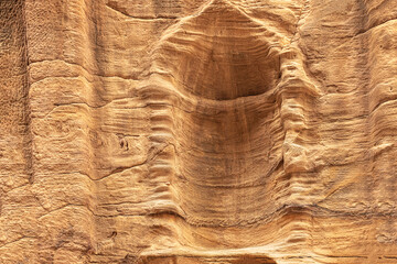 View of a wall with a man-made sandstone window. Petra, Jordan