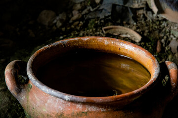 A round deep brown ceramic pot.
