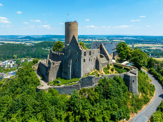 Ruins of medieval Gleiberg castle in Hesse, Germany, located on the top of a volcanic mountain. Aerial view in summer - 623236853