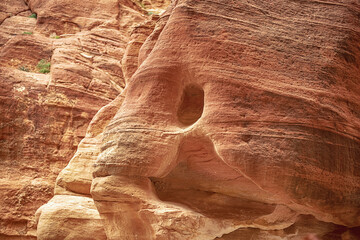 View of a wall with a man-made sandstone window. Petra, Jordan