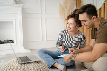 young couple man and woman having online class learn to draw on laptop