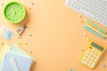Foundation for learning. Overhead shot of stationery, calculator, sticky notes, computer and other supplies on a pastel orange background. Capture attention with your back-to-school advertisements