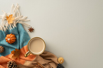 Coziness of being at home in autumn. Above view photo of a cup of hot coffee, patchy blanket,...