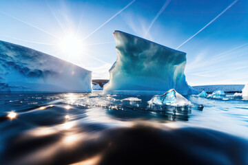 Arctic Reverie: Sunlit Majesty and Melting Ice Unveil the Fragility of the Mighty Iceberg