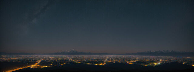 Nocturnal Tapestry: Mountainous Backdrop Illuminated by the Vibrant Cityscape