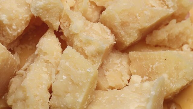 cheese parmesan pieces, rotation in circle. Italian aged hard cheese, Turning 