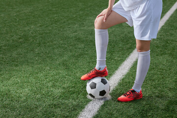 sports girl football player with a soccer ball on the soccer field, the concept of professional...
