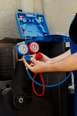 Knowleadgeable engineer calibrating manometers during comissioned outdoor hvac system monitoring....