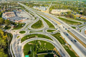 A drone view of a group of roundabouts and a highway