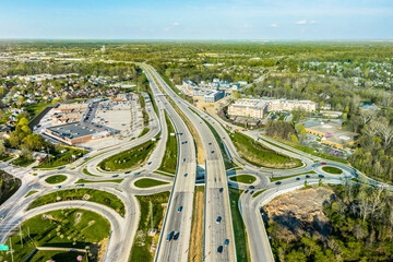 A drone view of a group of roundabouts and a highway