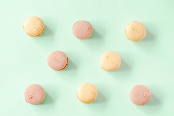 Sweet chocolate,lemon macarons,cookies lying on green background, pastry, confectionery desserts, tasty sugar food.copy space