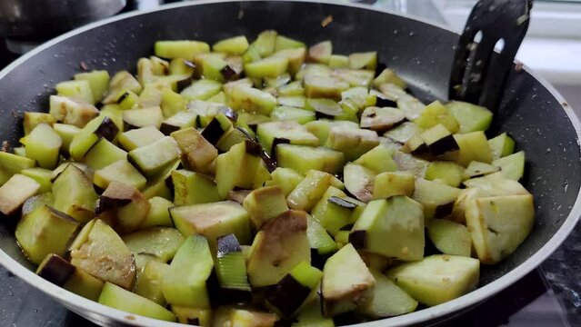chopped eggplants fried in a pan