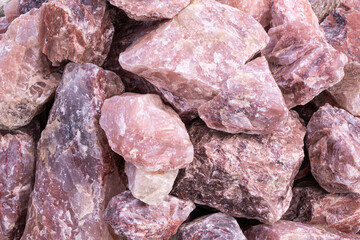 Heap of Raw Rose quartz rock stone mineral pieces
