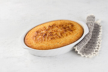 Freshly prepared mannik, semolina pie in the form on light gray background