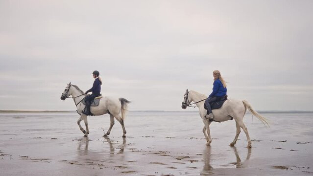 Women Riding Horse On Wet Soil