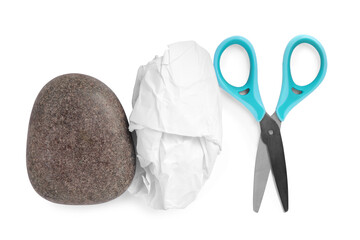 Rock, crumpled paper and scissors on white background, top view