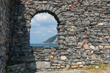 Stone arched window frames view over Ligurian sea