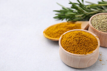 Aromatic curry powder on white table, closeup. Space for text