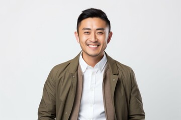 Portrait of a happy young asian man smiling on white background