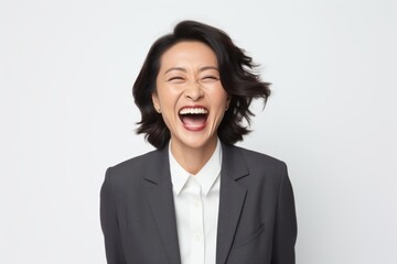 Obraz na płótnie Canvas Portrait of an excited businesswoman laughing isolated on a white background
