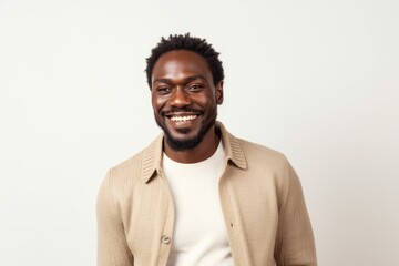 Obraz premium Portrait of a handsome african american man smiling against white background