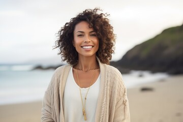 Portrait of smiling woman standing on the beach at the day time