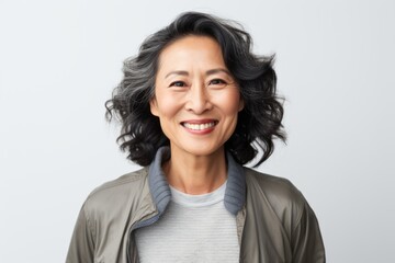 Portrait of a smiling middle-aged asian woman in casual clothes.